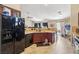 Kitchen with dark cabinets, light countertops, black appliances, and tile flooring at 2716 Orchid Moon Ct, North Las Vegas, NV 89031