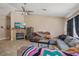Bright living room featuring a ceiling fan, a fireplace, and tile flooring at 2716 Orchid Moon Ct, North Las Vegas, NV 89031