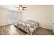 Bedroom with wood-look floors, natural light, and decorative ceiling fan at 2838 Geary Pl # 4017, Las Vegas, NV 89109
