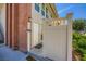 Close-up of the property's front door featuring a decorative security fence, brick, and lighting at 2838 Geary Pl # 4017, Las Vegas, NV 89109