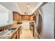 Kitchen features stainless appliances, warm wood cabinets, and a built-in washer/dryer at 2838 Geary Pl # 4017, Las Vegas, NV 89109