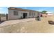 Large backyard with a brick patio, gravel area, BBQ, fire pit and block wall at 3108 Sentimental Ct, North Las Vegas, NV 89031