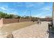 Large backyard with stone landscaping and perimeter wall, perfect for entertaining at 3108 Sentimental Ct, North Las Vegas, NV 89031