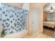 Bathroom featuring bathtub with shower and bathroom door on tile flooring at 3108 Sentimental Ct, North Las Vegas, NV 89031