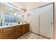 Bright bathroom with double sinks, a large mirror, and tub with shower at 3108 Sentimental Ct, North Las Vegas, NV 89031