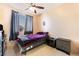 Bedroom with window, ceiling fan, and two black bedside tables at 3108 Sentimental Ct, North Las Vegas, NV 89031