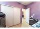 A simple bedroom with a closet and a lilac accent wall, offering a calm and personal space at 3108 Sentimental Ct, North Las Vegas, NV 89031