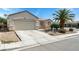 Single-story home featuring desert landscaping and a spacious two-car garage at 3108 Sentimental Ct, North Las Vegas, NV 89031