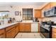 Functional kitchen featuring wood cabinetry and essential appliances at 3108 Sentimental Ct, North Las Vegas, NV 89031