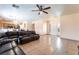 Open-concept living area with tile flooring, a ceiling fan, and a comfortable dark leather sofa at 3108 Sentimental Ct, North Las Vegas, NV 89031