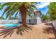 Backyard featuring a pool and mature palm trees at 3158 Brockington Dr, Las Vegas, NV 89120
