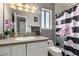 Granite counter tops over white cabinets with shower featuring patterned curtain at 3158 Brockington Dr, Las Vegas, NV 89120