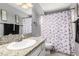 Bathroom with pink flamingo shower curtain, dark towels, and granite countertops at 3158 Brockington Dr, Las Vegas, NV 89120
