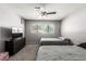 Comfortable bedroom with two beds, a ceiling fan, and a view of the neighborhood at 3158 Brockington Dr, Las Vegas, NV 89120