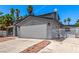 Exterior of home with a two-car garage and gated fence providing privacy and security at 3158 Brockington Dr, Las Vegas, NV 89120