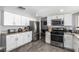 Modern kitchen featuring stainless steel appliances, granite countertops, and ample cabinet space at 3158 Brockington Dr, Las Vegas, NV 89120