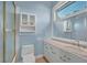 Bathroom featuring white cabinetry, double sinks, and walk-in shower at 3372 Westwind Rd, Las Vegas, NV 89146