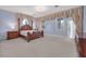 A Primary bedroom features an ornate four-poster bed, matching dressers, and large windows at 3372 Westwind Rd, Las Vegas, NV 89146