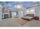 Large bedroom featuring a unique ceiling, a fireplace, and a cozy seating area at 3372 Westwind Rd, Las Vegas, NV 89146