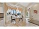 Bright dining area features elegant curtains, chandelier lighting, and tile flooring at 3372 Westwind Rd, Las Vegas, NV 89146
