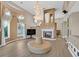 Bright living room with fireplace, chandelier, and large ottoman at 3372 Westwind Rd, Las Vegas, NV 89146