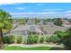 Lush backyard featuring green grass, mature trees, and a solar panel on the roof at 3372 Westwind Rd, Las Vegas, NV 89146