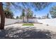 Spacious backyard featuring a minimalist design with gravel, bordered by a tall block fence for added privacy at 363 El Pico Dr, Henderson, NV 89014