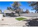 Spacious backyard features gravel and artificial turf complemented by a covered patio, perfect for outdoor relaxation at 363 El Pico Dr, Henderson, NV 89014