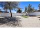 Spacious backyard with gravel, minimal grass and a white brick wall at 363 El Pico Dr, Henderson, NV 89014