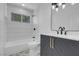 Well-lit bathroom with a shower over tub, stylish tile, and a modern vanity at 363 El Pico Dr, Henderson, NV 89014