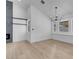 Bright dining room with a modern chandelier, large windows, and light wood flooring at 363 El Pico Dr, Henderson, NV 89014