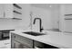 Contemporary kitchen island with a black sink, white countertop, and modern fixtures at 363 El Pico Dr, Henderson, NV 89014