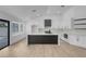 Open concept kitchen featuring an island with stainless steel appliances and hardwood floors at 363 El Pico Dr, Henderson, NV 89014