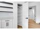 Pantry with white shelving, cabinets, and decorative backsplash at 363 El Pico Dr, Henderson, NV 89014