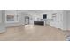 Open-concept living room with hardwood floors, modern light fixtures, and large windows overlooking the backyard at 363 El Pico Dr, Henderson, NV 89014