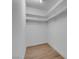 Empty walk-in closet featuring hardwood floors and custom shelves at 363 El Pico Dr, Henderson, NV 89014