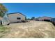 Dirt backyard area with white buildings, a small window, and plenty of space for upgrades at 3917 Leon Ave, Las Vegas, NV 89130