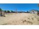 Expansive dirt backyard with some trees, chain link fencing, and open space for landscaping at 3917 Leon Ave, Las Vegas, NV 89130