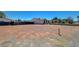 Vast dirt backyard in need of some TLC, with some fencing and a clear blue sky at 3917 Leon Ave, Las Vegas, NV 89130