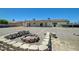 Backyard featuring a fire pit, covered patio, and well-maintained gravel landscaping at 3917 Leon Ave, Las Vegas, NV 89130
