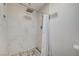 Modern bathroom with a walk-in shower featuring white tile and a pebble floor at 3917 Leon Ave, Las Vegas, NV 89130