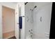 Tiled shower over tub with grab bars and a handheld shower head for added convenience at 3917 Leon Ave, Las Vegas, NV 89130
