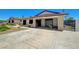 Spacious driveway leads to an attached garage with an open door, and a black iron security gate at 3917 Leon Ave, Las Vegas, NV 89130