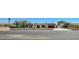 A single-story home with white walls, black shutters, and a brown roof as seen from the street at 3917 Leon Ave, Las Vegas, NV 89130