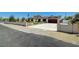 Single-story home with white and brick exterior, well-kept landscaping and a large driveway at 3917 Leon Ave, Las Vegas, NV 89130
