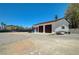 Detached garage with three bays and ample parking space in the expansive gravel backyard area at 3917 Leon Ave, Las Vegas, NV 89130
