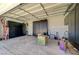 Attached garage with built-in black cabinets, painted walls, and a bright overhead light at 3917 Leon Ave, Las Vegas, NV 89130