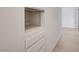 Bright hallway features built-in shelves with white trim, complemented by neutral walls and flooring at 3917 Leon Ave, Las Vegas, NV 89130