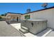 Backyard covered patio area featuring a hot tub, concrete foundation, and gravel landscaping at 3917 Leon Ave, Las Vegas, NV 89130