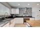 Kitchen features white cabinets, stainless steel appliances, and a unique backsplash at 3917 Leon Ave, Las Vegas, NV 89130